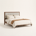 Studio angle | Walnut platform bed showing the side rail, footboard, and tapered leg