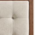 Linen detail | Light linen headboard button tuft beside walnut surround
