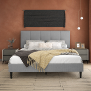 Terracotta bedroom | Light Gray low profile platform bed with a five-channel headboard, patterned bedding, dark nightstands, and a sand linear rug