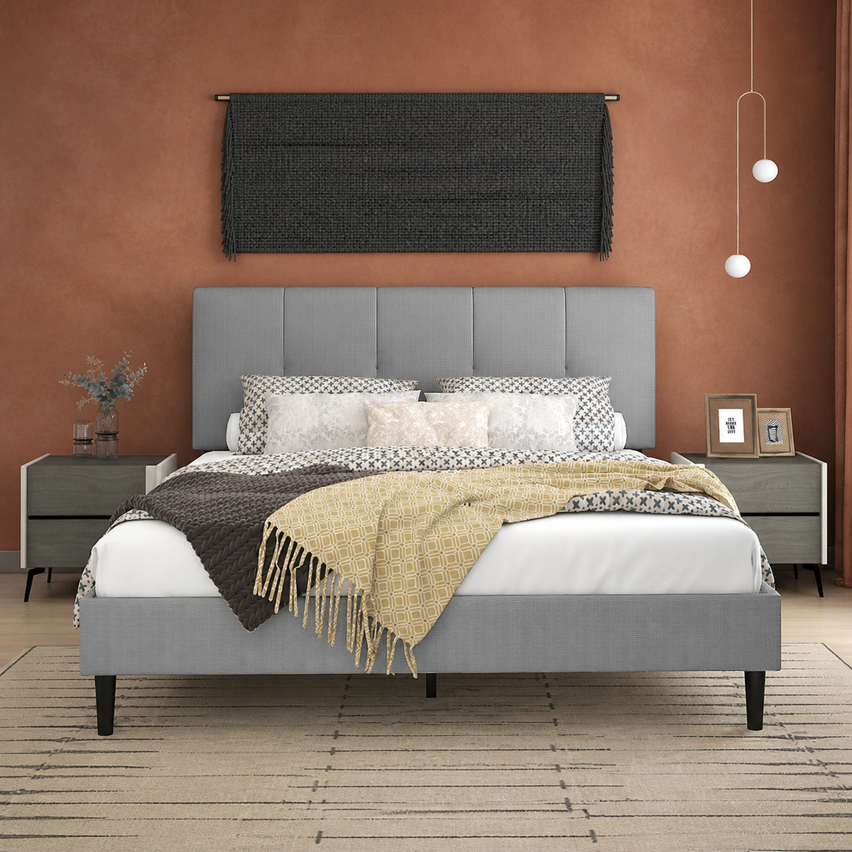 Terracotta bedroom | Light Gray low profile platform bed with a five-channel headboard, patterned bedding, dark nightstands, and a sand linear rug