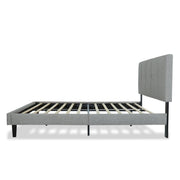 Studio side | Light Gray upholstered low profile platform bed with a vertical-channel headboard, low rails, wood slats, and black tapered legs on white