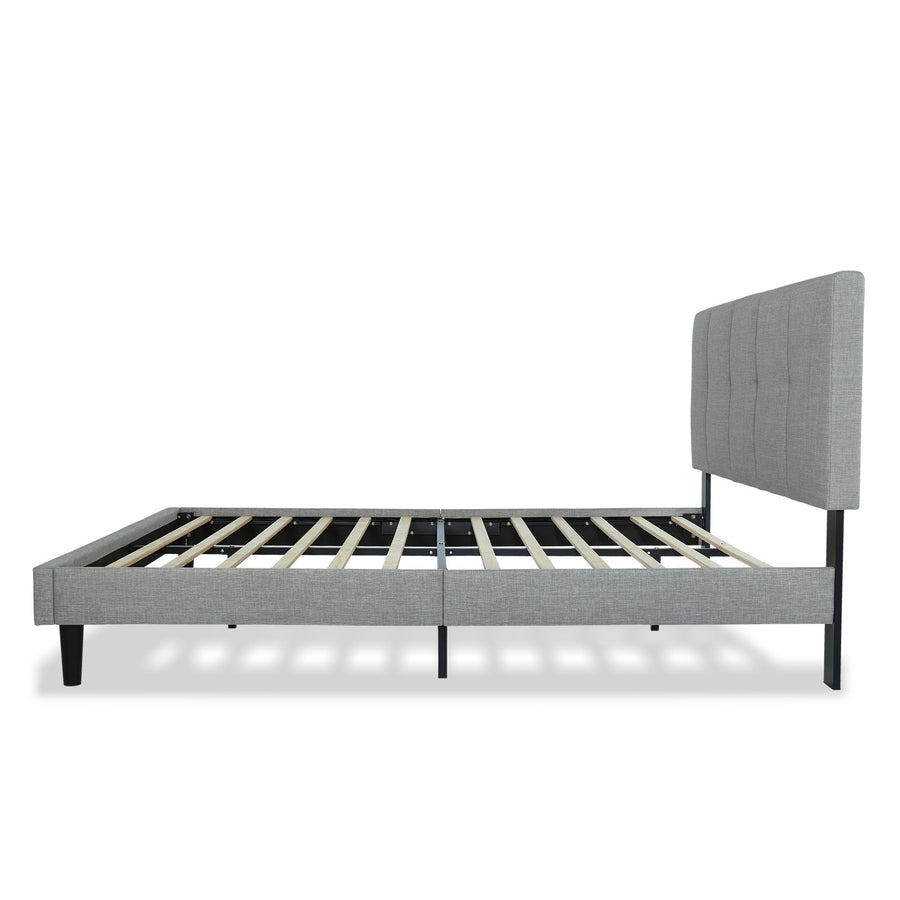 Studio side | Light Gray upholstered low profile platform bed with a vertical-channel headboard, low rails, wood slats, and black tapered legs on white