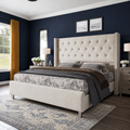 Midnight indigo bedroom | Three-quarter view of the Cream tufted wingback bed with ochre curtains and an ivory-and-indigo rug
