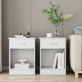 Nightstand detail | Untouched view of two matching white one-drawer nightstands beside the Beige bed