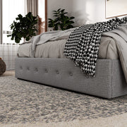 Side rail detail | tufted dark charcoal side rail with houndstooth throw and storage boxes