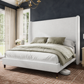 Charcoal bedroom angle | White upholstered wingback bed with oatmeal curtains and rust geometric rug