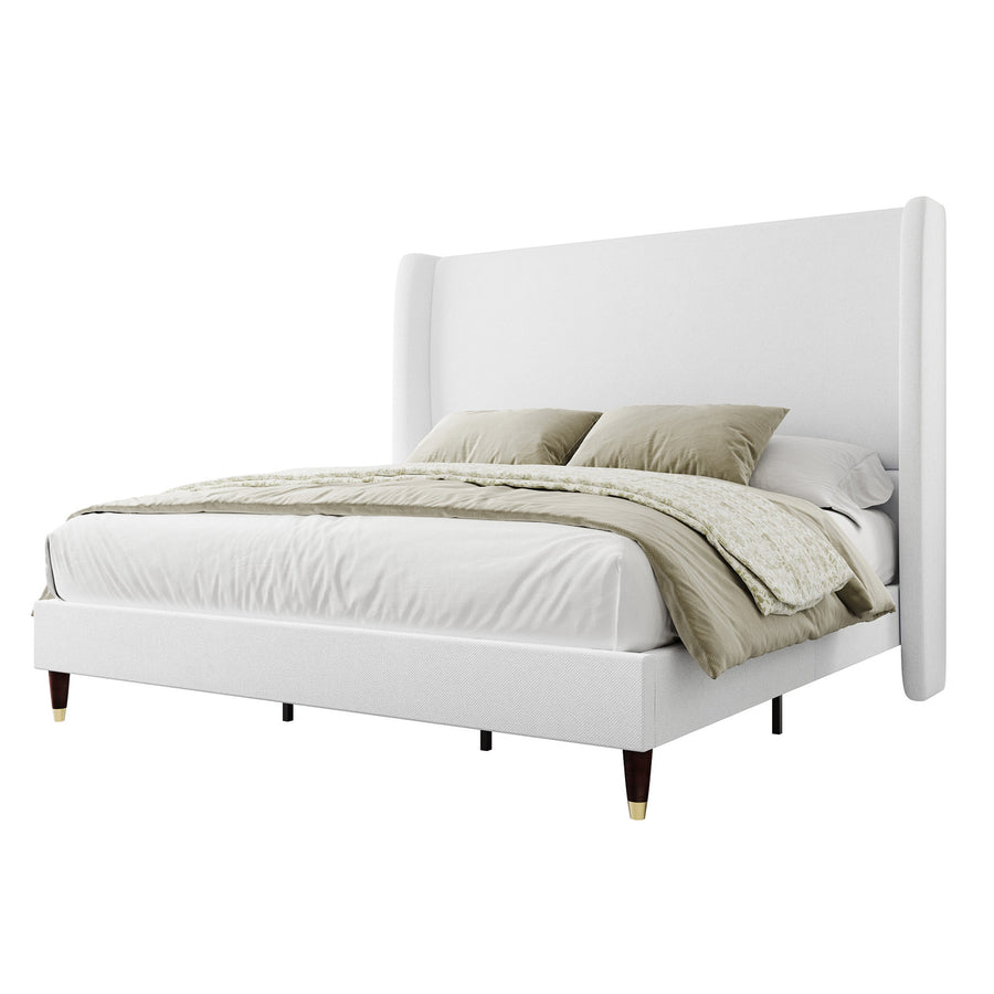 Studio angle | White upholstered wingback bed with tapered dark wood legs