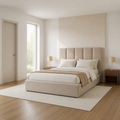 In scale | Beige upholstered bed in a pale bedroom with a full-height doorway and window visible for scale