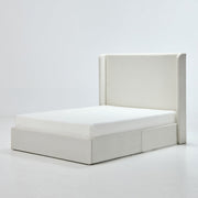 Studio angle | Ivory canvas wingback bed with a low upholstered plinth