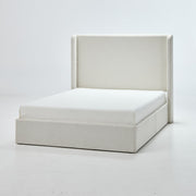 Studio front angle | Ivory canvas wingback bed with a broad plain headboard