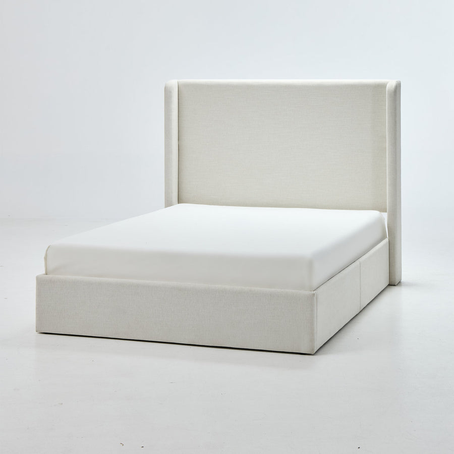Studio front angle | Ivory canvas wingback bed with a broad plain headboard