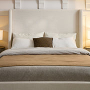 Headboard close view | Ivory canvas wings framing layered pillows