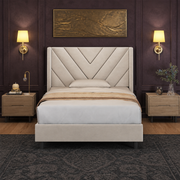 Aubergine bedroom | Beige velvet chevron-tufted wingback bed centered against dark plaster walls with brass relief art