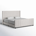 Studio angle | Cream velvet channel tufted bed from the front right on a white seamless background