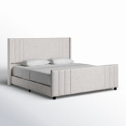 Studio angle | Cream velvet channel tufted bed from the front right on a white seamless background