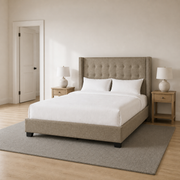 Scale | Beige linen wingback bed beside a full interior doorway