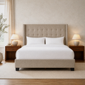 Warm bedroom | Beige linen wingback bed with button-tufted headboard and silver nailhead wings