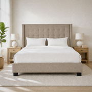Airy bedroom | Beige linen wingback bed with pale oak nightstands and morning light