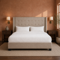 Clay bedroom | Beige linen wingback bed with walnut nightstands and warm terracotta walls