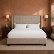Clay bedroom | Beige linen wingback bed with walnut nightstands and warm terracotta walls