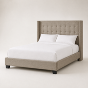Studio angle | Front-right view showing the wing depth, upholstered rail, footboard, and dark feet