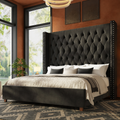 Terracotta bedroom angle | Black velvet diamond-tufted wingback bed with silver nailhead trim