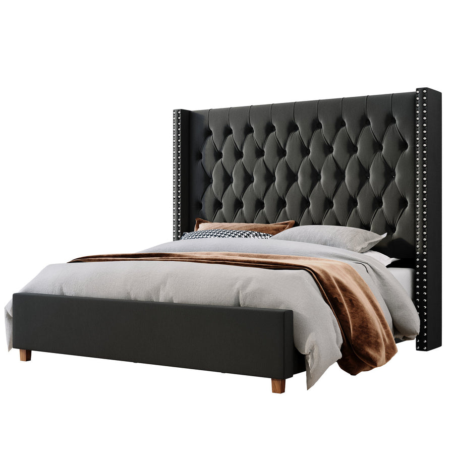 Studio angle | Black velvet diamond-tufted wingback bed on a seamless white background