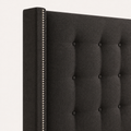 Nailhead detail | Silver nailhead trim along a charcoal squared wing with button tufts