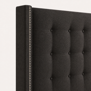Nailhead detail | Silver nailhead trim along a charcoal squared wing with button tufts