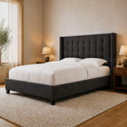 Warm bedroom angle | Charcoal wingback bed from a front corner with walnut nightstands and a plain ivory rug