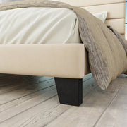 Foot and rail detail | Cream upholstered rail above a dark tapered foot