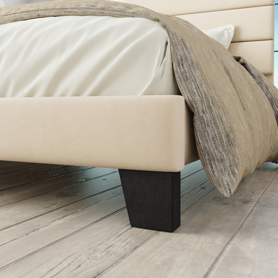 Foot and rail detail | Cream upholstered rail above a dark tapered foot