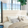 Headboard detail | Three horizontal cream upholstered panels with smooth padding