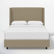 Studio front | Natural textured linen wingback bed with a continuous headboard and low footboard