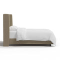 Studio side | Right profile of the natural linen wingback headboard, rail and dark feet