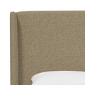 Headboard detail | Natural textured linen upholstery across the rounded wing and headboard panel
