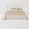 Studio front | cream velvet channel wingback bed with layered neutral bedding
