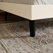 Rail and leg detail | cream upholstered bed rail with a tapered black leg
