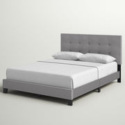 Studio angle | Front-left view of the Glacier gray tufted bed with white bedding