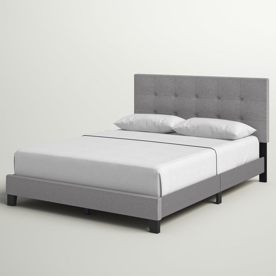 Studio angle | Front-left view of the Glacier gray tufted bed with white bedding