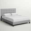 Studio angle | Front-right view of the Glacier gray tufted bed with white bedding