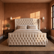 Terracotta bedroom | cream velvet tufted wingback bed with brass sconces