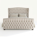 Studio front | cream velvet camelback wingback bed with tufted footboard and nailhead trim