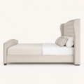 Studio side | right profile showing wing, upholstered rail, footboard and dark block feet