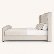 Studio side | right profile showing wing, upholstered rail, footboard and dark block feet