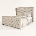 Studio angle | front-right view of cream velvet wingback bed, tufted footboard and dark feet