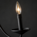 Hardware | close view of a black candle cup, socket, and clear flame-shaped candelabra bulb