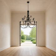 Scale | black chandelier hanging in front of a full-height open doorway for a clear size reference