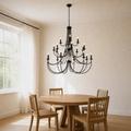 Dining room angle | lower corner view of the black chandelier above the round pale-oak table