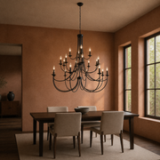 Clay dining room | black three-tier chandelier above a dark walnut table with four upholstered chairs